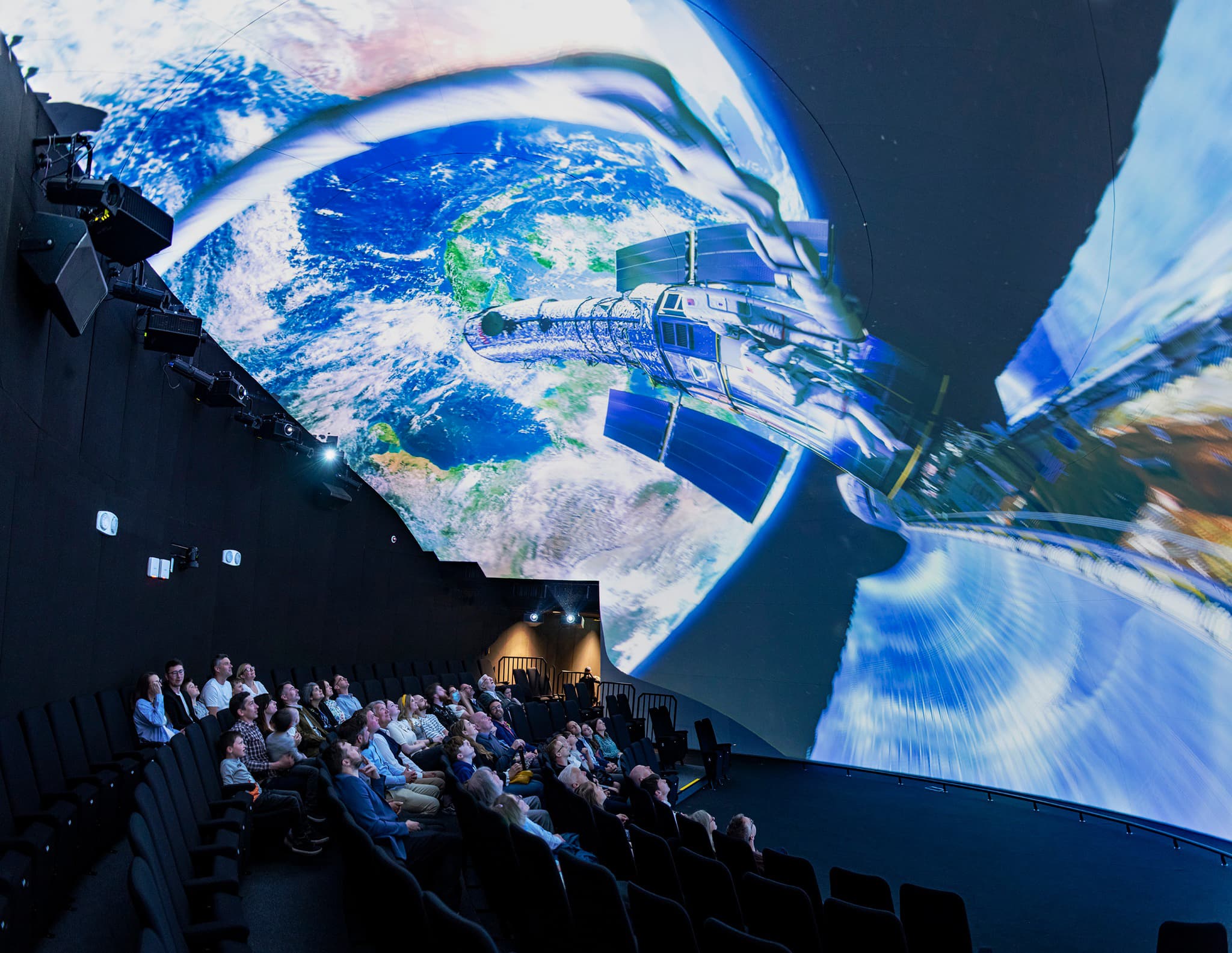 People viewing immersive imagery in a 21m Space Dome planetarium powered by a Screenberry media server.